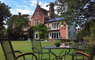 Front view of The Old Vicarage looking across the garden