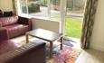 Spreacombe Gardens lounge area with table self catering cottages