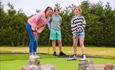 mother and two children playing mini golf @ The Milky Way Adventure Park