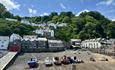 Clovelly in the summer with blue sky and boats on the shore