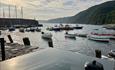 Boats docked in Clovelly under a pale sunset