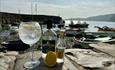 A gin and tonic on the shore of Clovelly beahc, next to the bottle of Northshore Gin, Fevertree tonic and a lemon