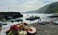 A plate of fresh fish, including a lobster, served on Clovelly beach