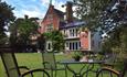 Front view of The Old Vicarage looking across the garden