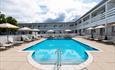 wide angle of the outdoor swimming pool at The Barnstaple Hotel, featuring sun loungers and umbrellas on the poolside