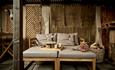 Two loungers in a wooden garden.
